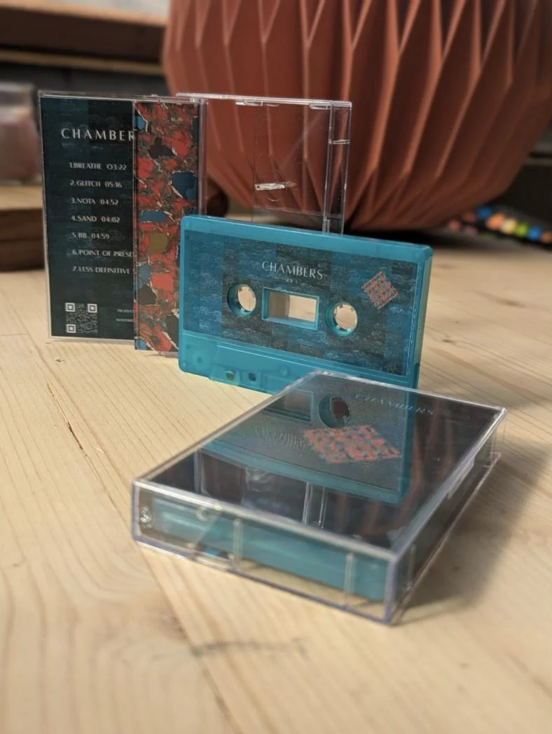The Chambers cassette: teal tape, clear case and J-card
